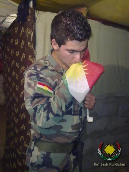 Syrian young kissing kurdistan flag