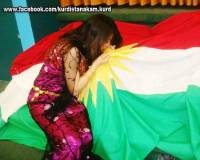 Girl kissing Kkurdistan flag